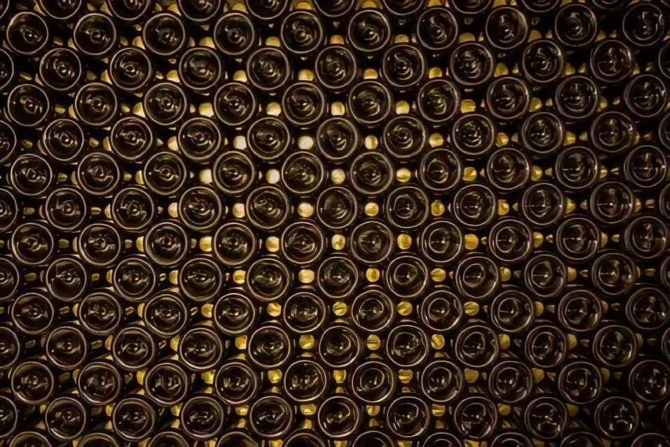 Stacked wine bottles in a cellar.